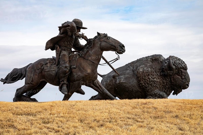Oakley, Kansas - A sculpture of Buffalo Bill (William Frederick Cody) on horseback shooting a buffalo at the Buffalo Bill Cultural Center. The sculpture is by Charlie Norton.