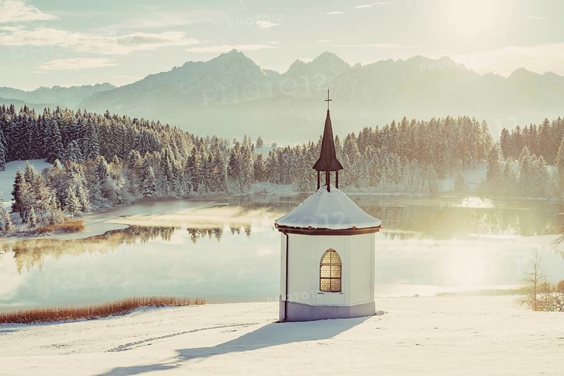 Chapel by the lake in the wintry snow-covered Allgäu near Halblech in front of an impressive mountain landscape, Bavaria, Germany, Europe