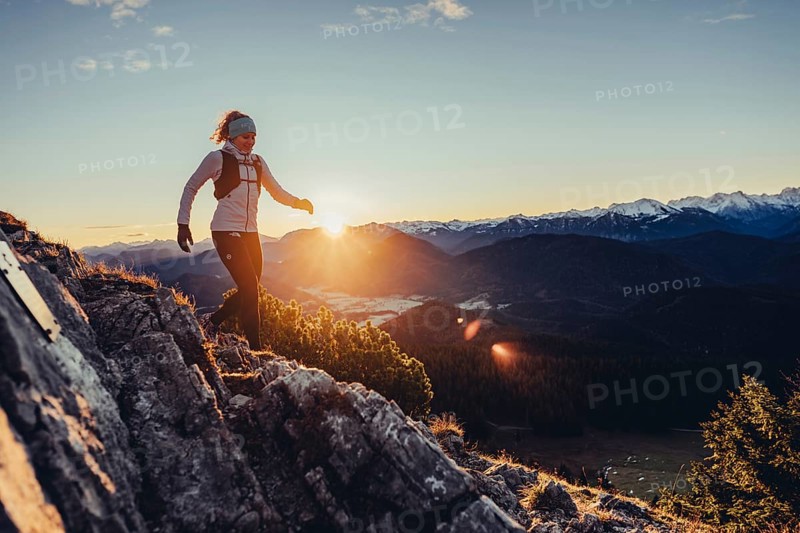 Trail running in autumn on the Jochberg on Lake Walchensee against the wonderful backdrop of the Alps, Bavaria, Germany, Europe