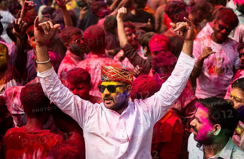 Revellers smear with Gulal or coloured powder and dance to play Holi, the Hindu spring festival of colours, on March 14, 2025 in Guwahati, India, Asia