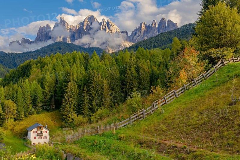 View of the partly cloudy Geisler group with a garden and a house in the foreground, Dolomites, Geisler group, Peitlerkofel group, St. Magdalena, Villnöß, Funes, Villnößtal, South Tyrol, Italy, Europe