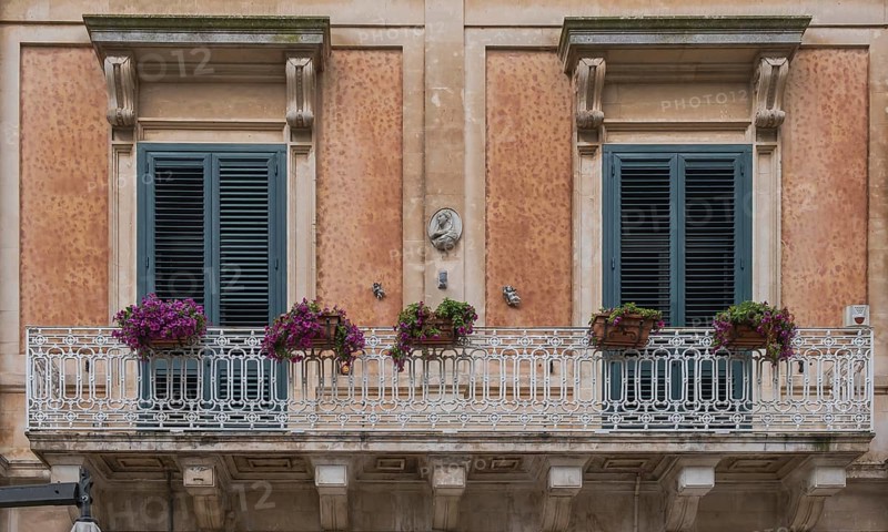 Historic building with balcony and floral decoration, Martina Franca, Apulia, Italy, Europe
