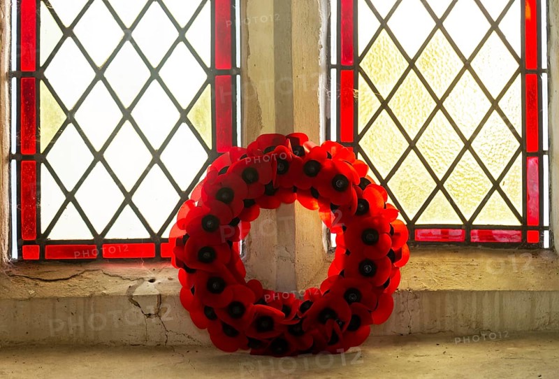 Poppy wreath in church window Remembrance events, Framsden church, Suffolk, England, UK