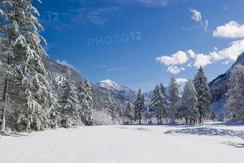 Eng valley in winter. Snow covered landscape with the Riss creek flowing through. Some hoar frosted trees