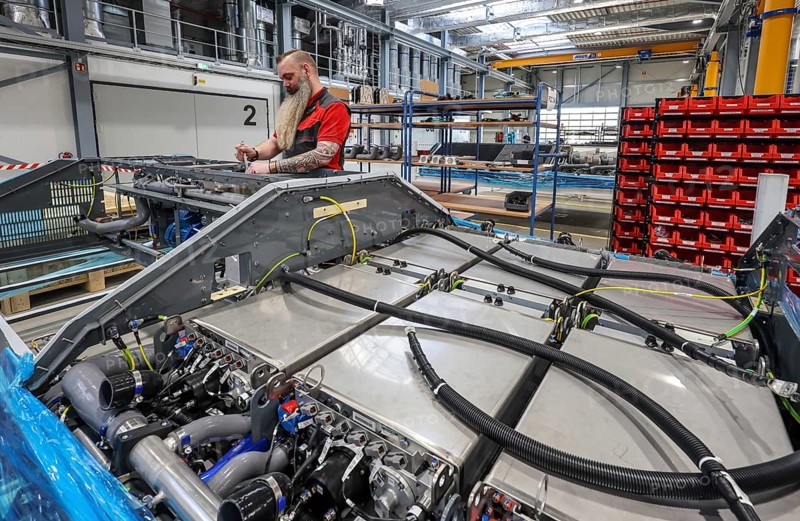 Herten, North Rhine-Westphalia, Germany, Cummins Hydrogenics fuel cell factory. An employee assembles fuel cell systems for Alstom's Coradia iLint hydrogen trains. The Coradia iLint is the world's first passenger train to be powered by a hydrogen fuel cell, which generates electrical energy for propulsion. Six fuel cell modules are installed in each train (right in the picture) . Note: The person pictured has given their verbal consent for publication in the press, Europe