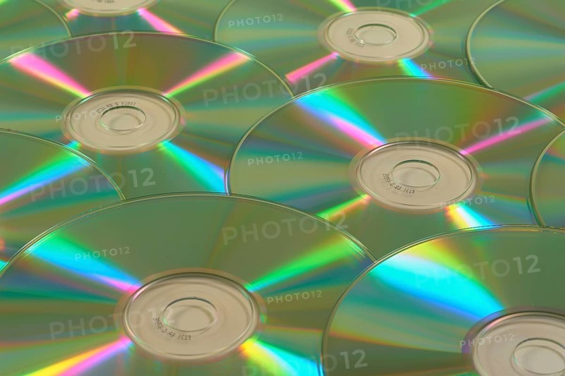 Several CD-ROMs with rainbow effect on the surface, close-up