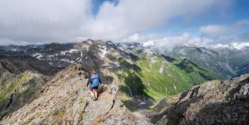 Mountaineer on a steep rocky ridge, on the summit of the Lasörling, view of the mountain panorama of the Venediger Group, Lasörling Group, Hohe Tauern National Park, East Tyrol, Tyrol, Austria, Europe