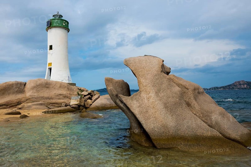 Lighthouse with beach and bizarre granite rocks, Spiaggia Porto Faro, Faro di Punta Palau, Palau, Costa Smeralda, Sardinia, Italy, Oceania
