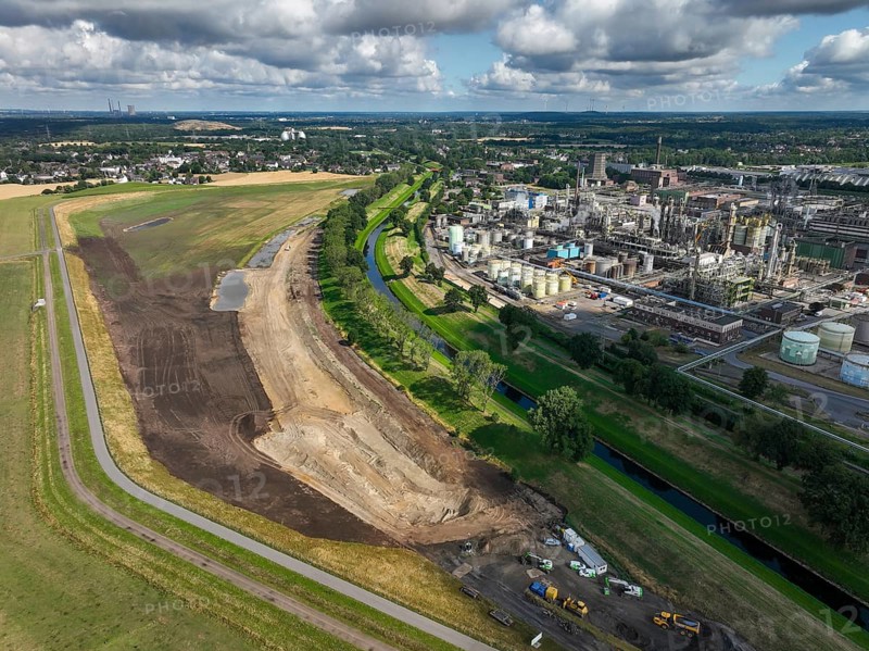 Oberhausen, North Rhine-Westphalia, Germany, renaturalisation of the Emscher in the Holtener Bruch. A new floodplain landscape for flood protection and biodiversity is being created here. On the right, OQ Chemicals plant Ruhrchemie. The Emscher, which is currently straightened, is given curves again and can meander through its new floodplain. The ecological reorganisation of the Emscher system consists of the construction of a central wastewater treatment system in the Ruhr area, the construction of sewers and the renaturation of the Emscher and its tributaries. Following the construction of a parallel sewer, the Emscher has been completely free of sewage since January 2022. The river was previously an open, above-ground combined sewer with rainwater and wastewater, Europe