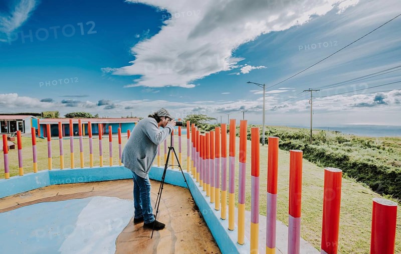 Person photographing landscape with a digital camera in a park. Photographer photographing a beautiful landscape