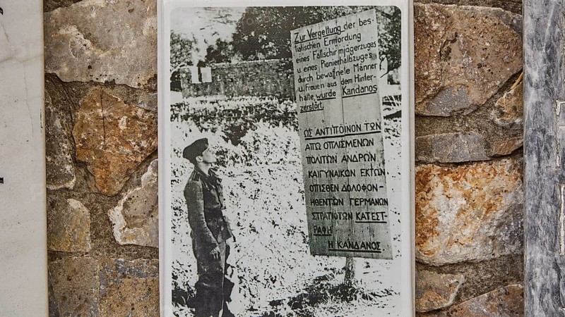 Black and white photo of a soldier on a memorial plaque on a stone wall, visit of Federal President Frank-Walter Steinmeier to Kandanos on 31 October 2024, Federal President, Frank-Walter Steinmeier, memorial, war crimes, Nazis, Wehrmacht crimes, World War II, Kandanos, southwest Crete, Crete, Greek islands, Greece, Europe