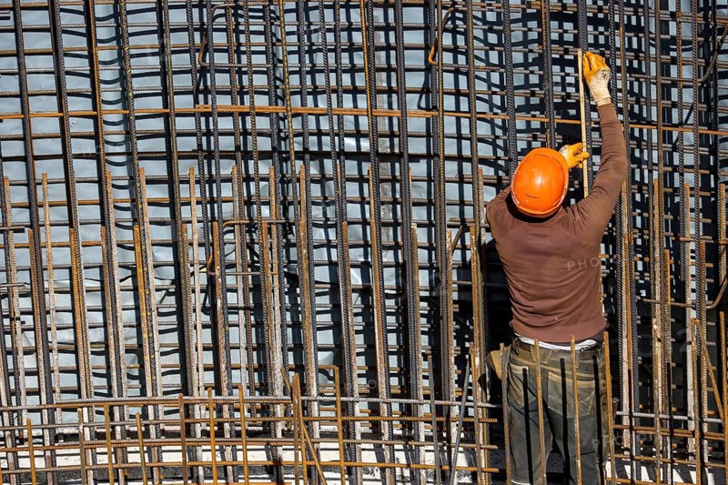 Essen, North Rhine-Westphalia, Germany, construction industry, construction workers working on a building site. Iron binder is a job title for construction workers who bind reinforcing mesh for the reinforcement of concrete parts. The meshes are prepared together with the formwork builder to form moulds, which are then filled with fresh concrete, Europe