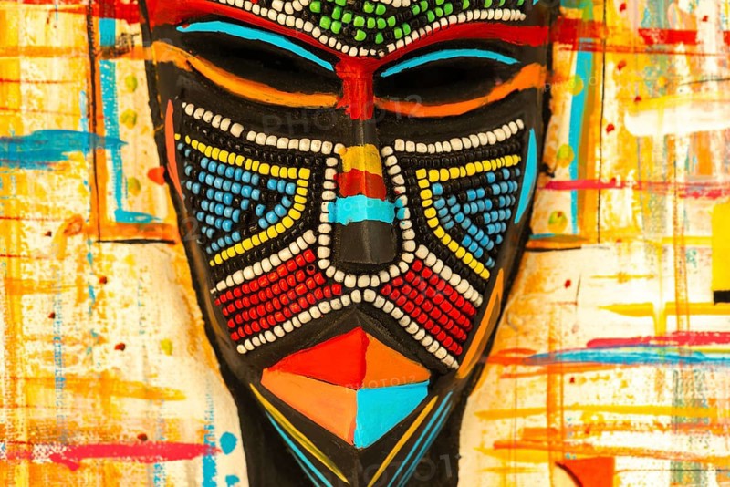 Ghanaian woman as a three-dimensional work of art by a Ghanaian artist, a colourful work of art on canvas, upper part with abstract painting, face mask with artificial pearls, dress made of individual textiles, Ghana, Africa