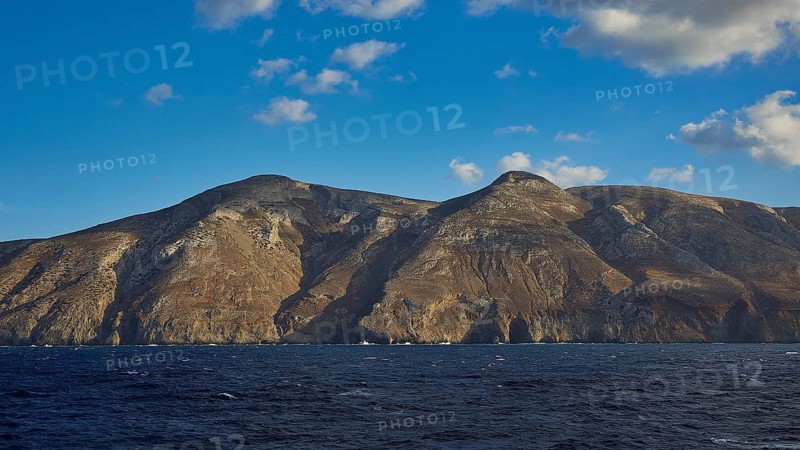 View of a rocky coastline under a clear blue sky, Kassos Island, neighbouring island of Karpathos, Dodecanese, Greek Islands, Greece, Europe