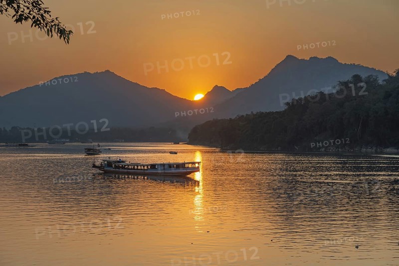 Sunset on the Mekong with excursion boats, near Luang Prabang, Laos, Asia