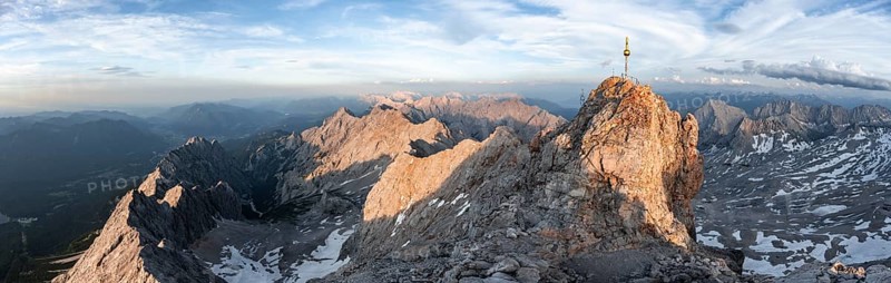 Impressive rocky mountain landscape in the evening light, summit of the Zugspitze with summit cross, steep mountain ridge Jubiläumsgrat and Waxensteinkamm, view into the Höllental, mountain panorama from the Zugspitze, Wetterstein range, Bavaria, Germany, Europe