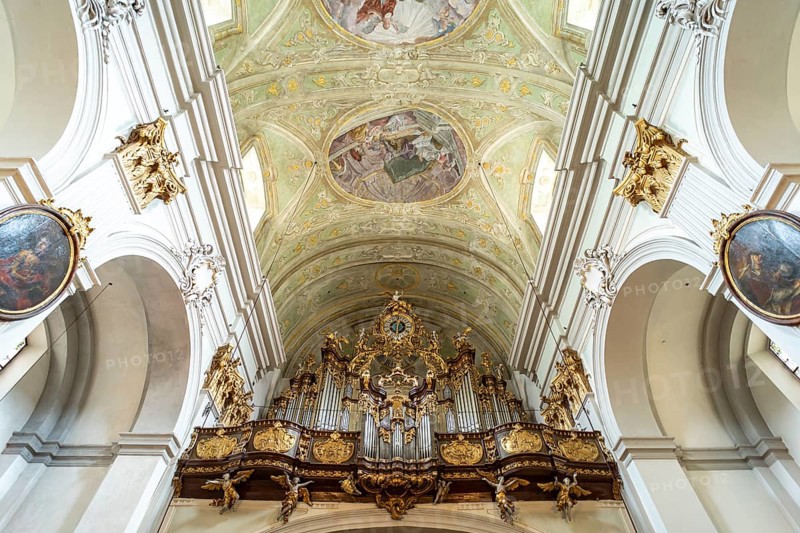 Church organ and ceiling frescoes in the baroque parish church Mariahilfer Kirche in Vienna, Austria, Europe