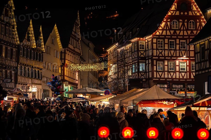 Densely packed crowd at an atmospherically illuminated Christmas market with half-timbered houses, Christmas market Calw, Black Forest, Germany, Europe