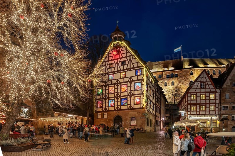 Historic Pilkatushaus with an Advent calendar on 18 December 2024 at dusk, behind the Imperial Castle, Tiergärtnertorplatz, Nuremberg, Middle Franconia, Bavaria, Germany, Europe