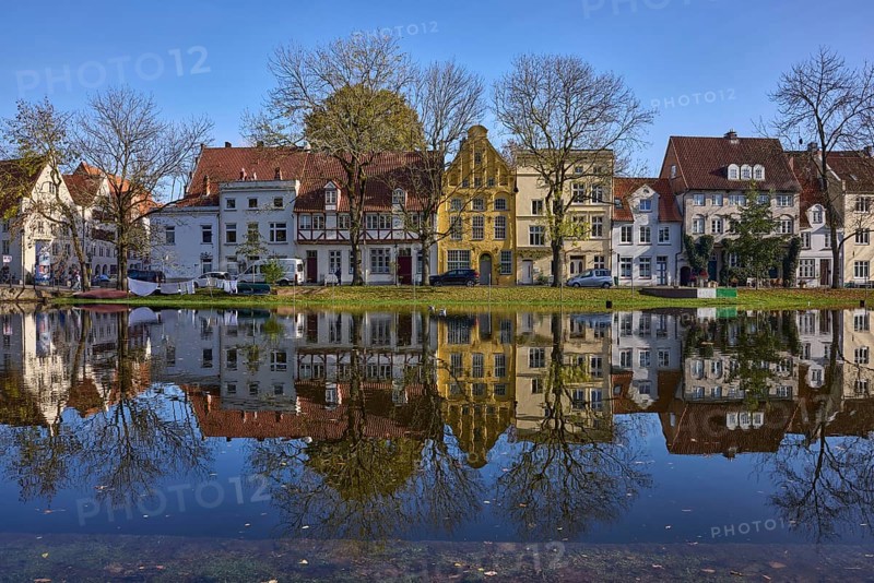 Historic houses, symmetrical reflections on the water surface, river Trave, cloudless blue sky, old town, Hanseatic city of Lübeck, independent city, Schleswig-Holstein, Germany, Europe