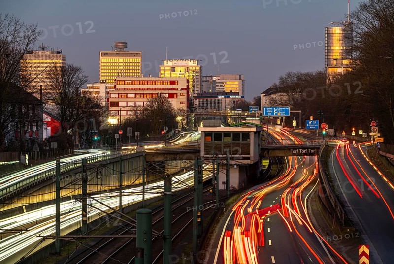 Motorway A40, Ruhr expressway, heavy traffic jam, rush hour, city passage in Essen, skyline of the city centre, underground line between the lanes, Hobeisenbrücke stop, North Rhine-Westphalia, Germany, Europe