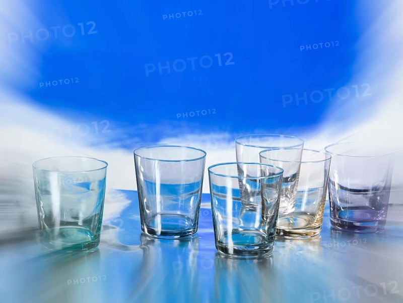 Various glasses on silver foil, blue colour area behind, zoom effect, studio shot