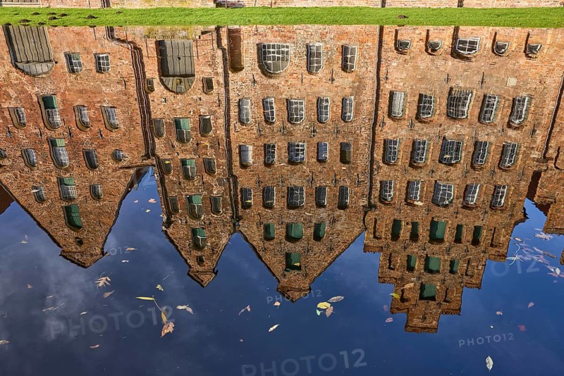 Reflections on the water surface of the Trave, salt warehouse, historic brick buildings, Hanseatic city of Lübeck, Schleswig-Holstein, Germany, Europe