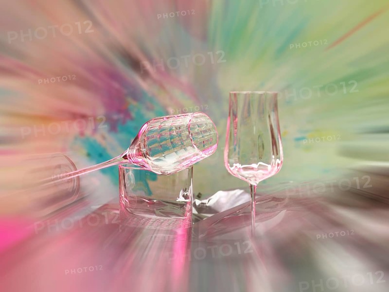 Light art, various glasses on silver foil, behind them various splashes of colour, zoom effect, studio shot