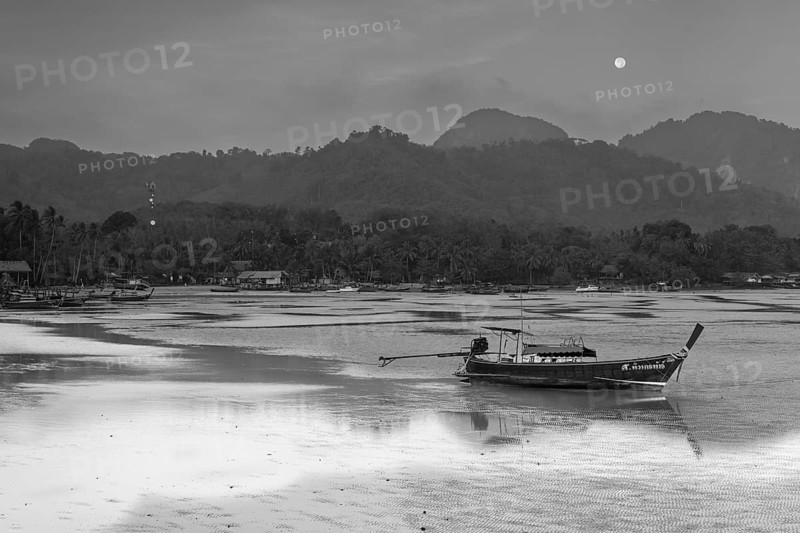Before sunrise, longtail boats lie at low tide in the harbour at Sivalai Beach, Koh Mook Island, Satun Province, Southern Thailand, Thailand, Asia