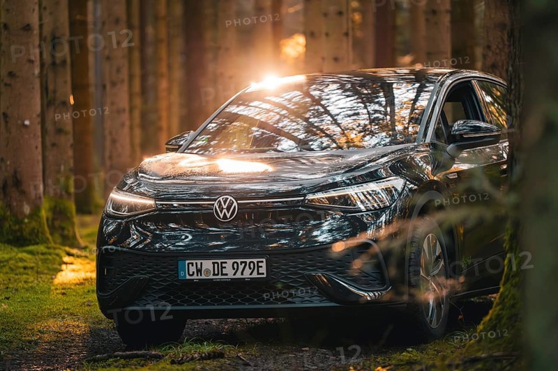 Black car in the forest with sun rays and reflections on the surface, car sharing vehicle Deer Mobility, electric car VW ID5, Black Forest, Germany, Europe