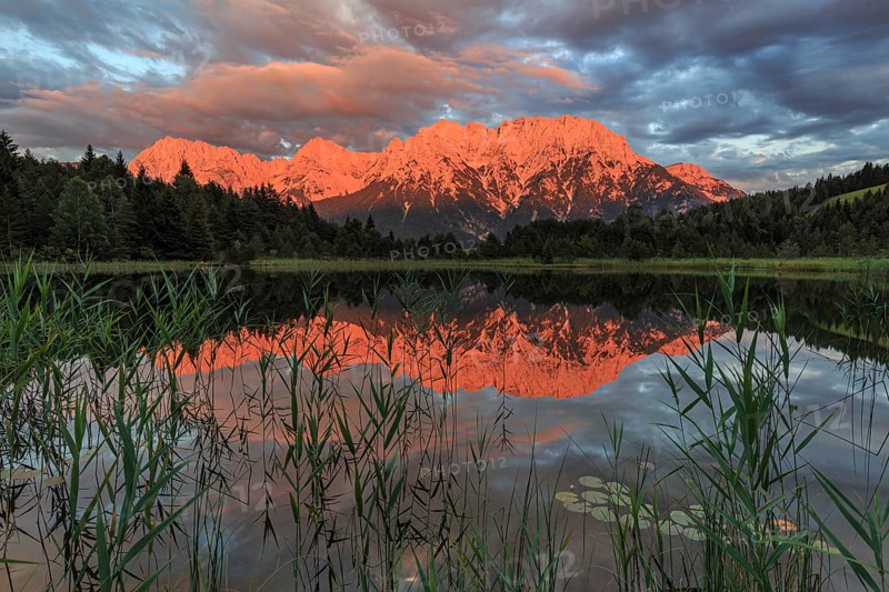 Mountains and clouds reflected in lake, evening light, cloudy mood, summer, Luttensee, Mittenwald, Karwendel Mountains, Bavaria, Germany, Europe