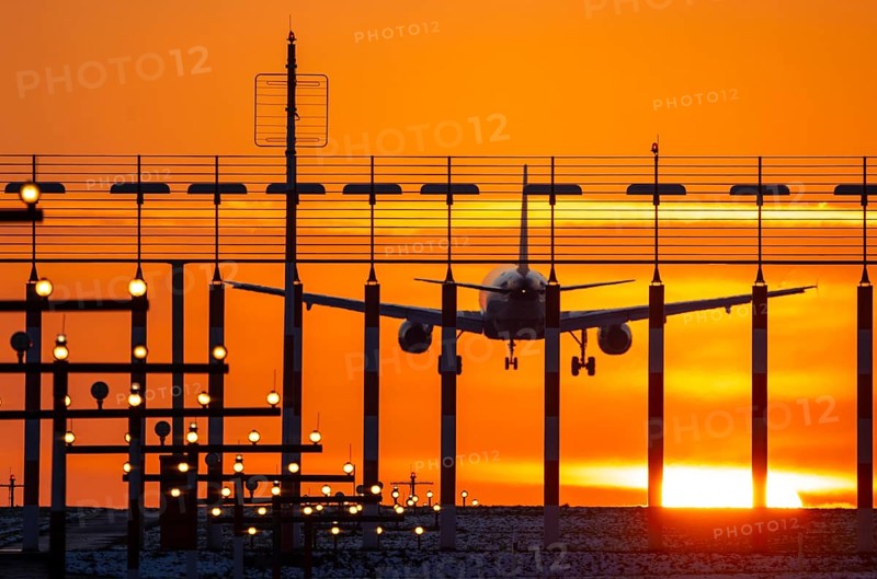 Aircraft approaching the main runway south, 05R/23L, runway lighting, approach aids, at Düsseldorf International Airport, sunset, North Rhine-Westphalia, Germany, Europe