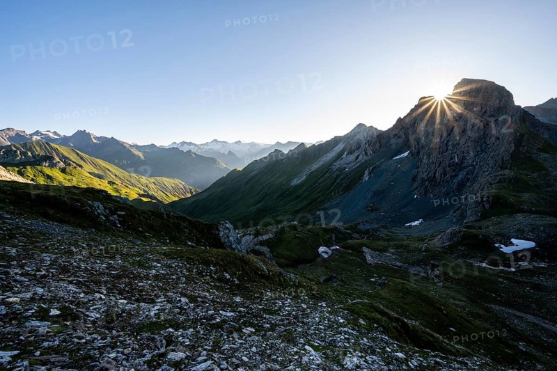 Mountain landscape at sunrise with sun star, view of mountain peaks of the Venediger group and into the Großbachtal valley from the summit of Bachlenkenkopf, Lasörling group, Hohe Tauern National Park, East Tyrol, Tyrol, Austria, Europe