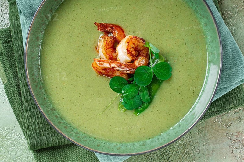 Pea cream soup, with shrimp, green soup, homemade, top view, no people