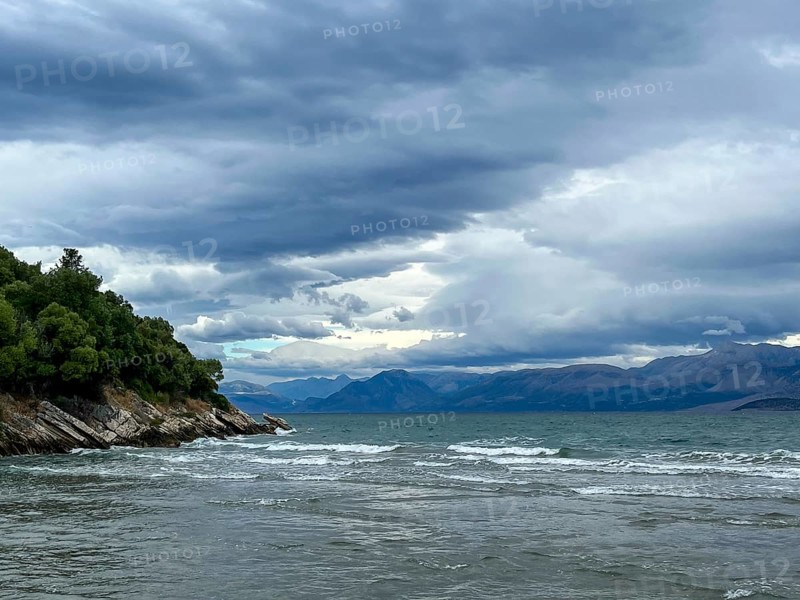 Kalamaki, Corfu, Greece, View from Kalamaki beach in the north-east of the Greek island of Corfu over the Ionian Sea towards the mainland of Albania near the town of Saranda, Europe
