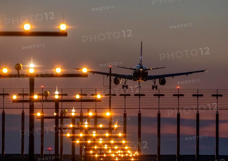 Aircraft approaching the main runway south, 05R/23L, runway lighting, approach aids, at Düsseldorf International Airport, sunset, North Rhine-Westphalia, Germany, Europe