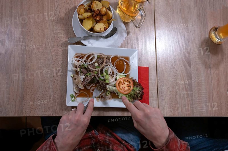 Pork brawn with onion and fried potatoes served in a Franconian restaurant, Bavaria, Germany, Europe