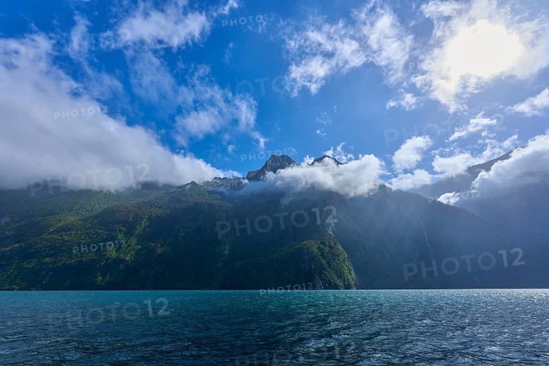 Cloudy sky over a quiet, green mountain landscape, summer, Milford Sound, Te Anau, Fiordland National Park, South Island, New Zealand, Oceania