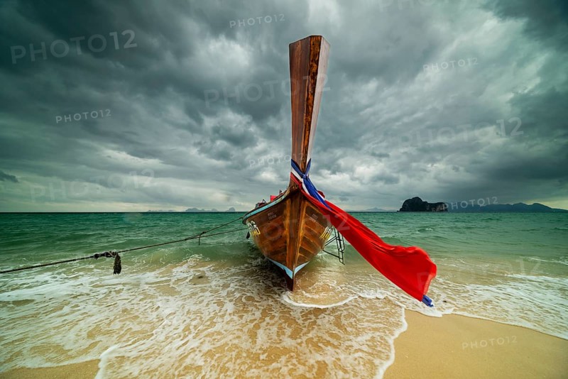 Longtail boat on the beach, dark rain clouds behind, Koh Ngai Island, Andaman Sea, Satun Province, Southern Thailand, Thailand, Asia