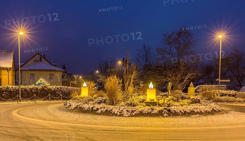Advent candles at the roundabout, illuminated, snowy and at dusk, Coswig, Saxony, Germany, Europe
