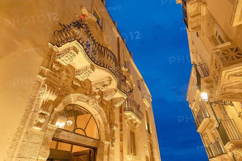 Historic district traditional buildings illuminated at dusk, Ortygia, Syracuse, Sicily, Italy, Europe
