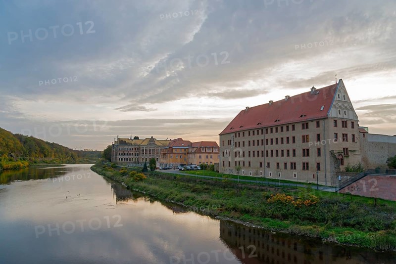 River landscape with buildings along the bank at dusk and reflection in the water, River Mulde, Grimma, Leipzig, Saxony, Germany, Europe
