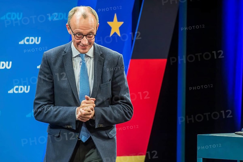 Election event of the CDU party for the Bundestag elections with top candidate Friedrich Merz. Portrait in front of the German flag and the flag of the European Union. Singen am Hohentwiehl. Baden-Württemberg, Germany, Europe