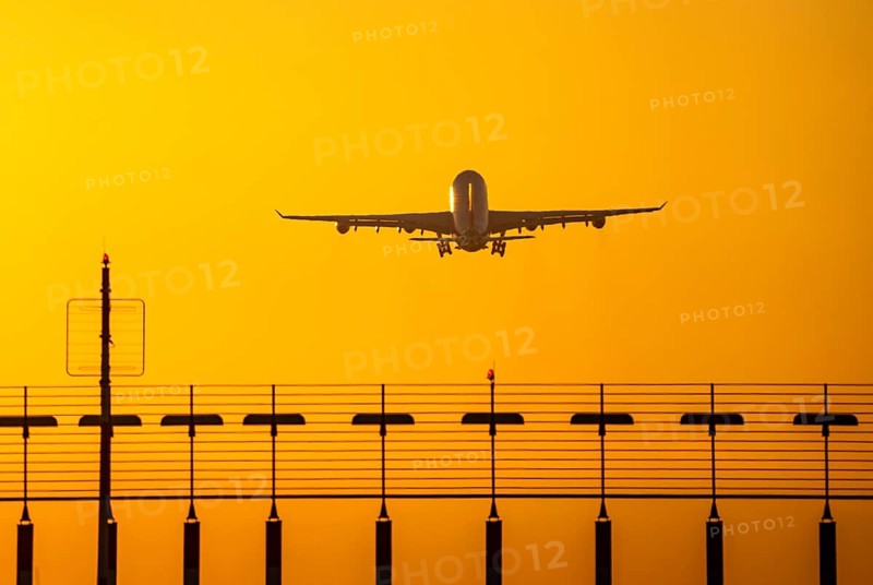 Aircraft taking off from the main runway south, 05R/23L, runway lighting, approach aids, at Düsseldorf International Airport, sunset, North Rhine-Westphalia, Germany, Europe