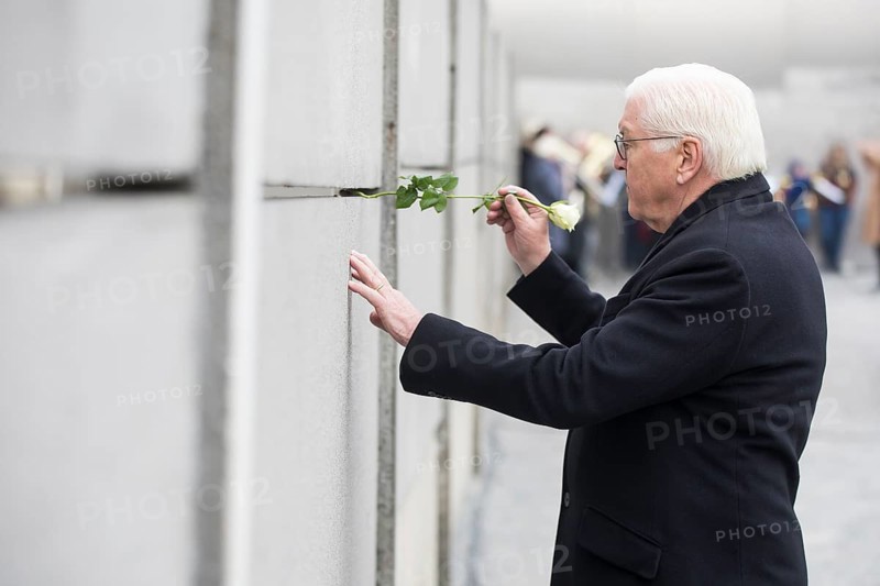 Frank-Walter Steinmeier (President of the Federal Republic of Germany) sticks a rose into the Wall at the central commemorative event at the Berlin Wall Memorial to mark the 35th anniversary of the fall of the Wall in Berlin, 9 November 2024