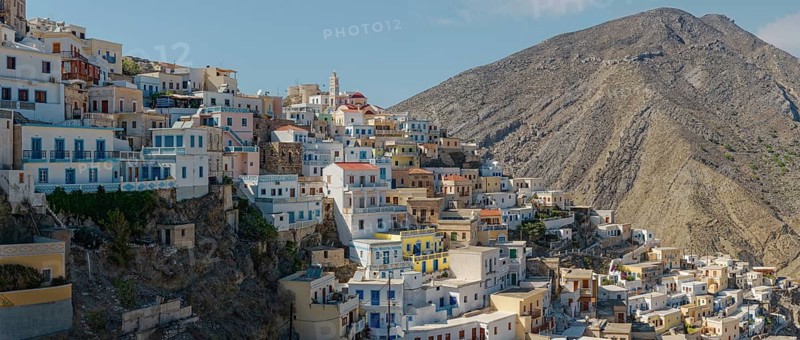 Tightly packed houses on the mountainside of the Mediterranean and picturesque village of Olymbos, Olymbos, Karpathos, Greece, Europe