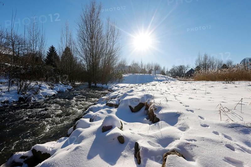 Dortmund, North Rhine-Westphalia, Germany - Sunny winter landscape in the Ruhr area, ice and snow on the renaturalised Emscher, the ecological conversion of the Emscher system consists of the construction of a central wastewater treatment system in the Ruhr area, the construction of underground sewers and the renaturalisation of the Emscher and its tributaries