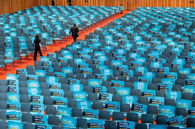 Assembly hall, deserted with many empty chairs and posters with the inscription UNSER KANNZLER. Bundestag election campaign of the CDU party for the party's candidate for chancellor Friedrich Merz, symbolic photo. Election rally in Künzelsau, Baden-Württemberg, Germany, Europe