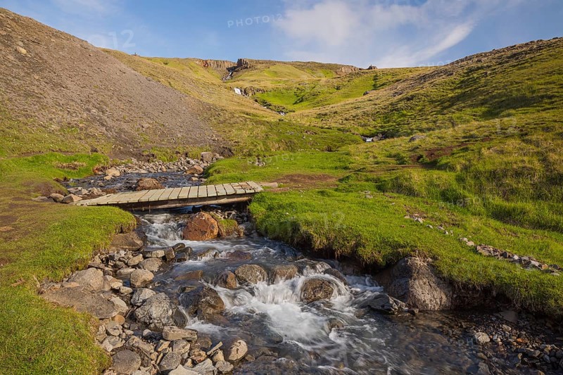 Flowing water below the waterfall. Hengifoss waterfall is located in Hengifossá in Fljótsdalshreppur, East Iceland. With 128 meters it is the third highest waterfall in Iceland