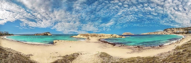 Wide panorama of Frangolimiona sandy beach with turquoise sea and slightly cloudy sky, Arkasa, Karpathos island, Greece, Europe